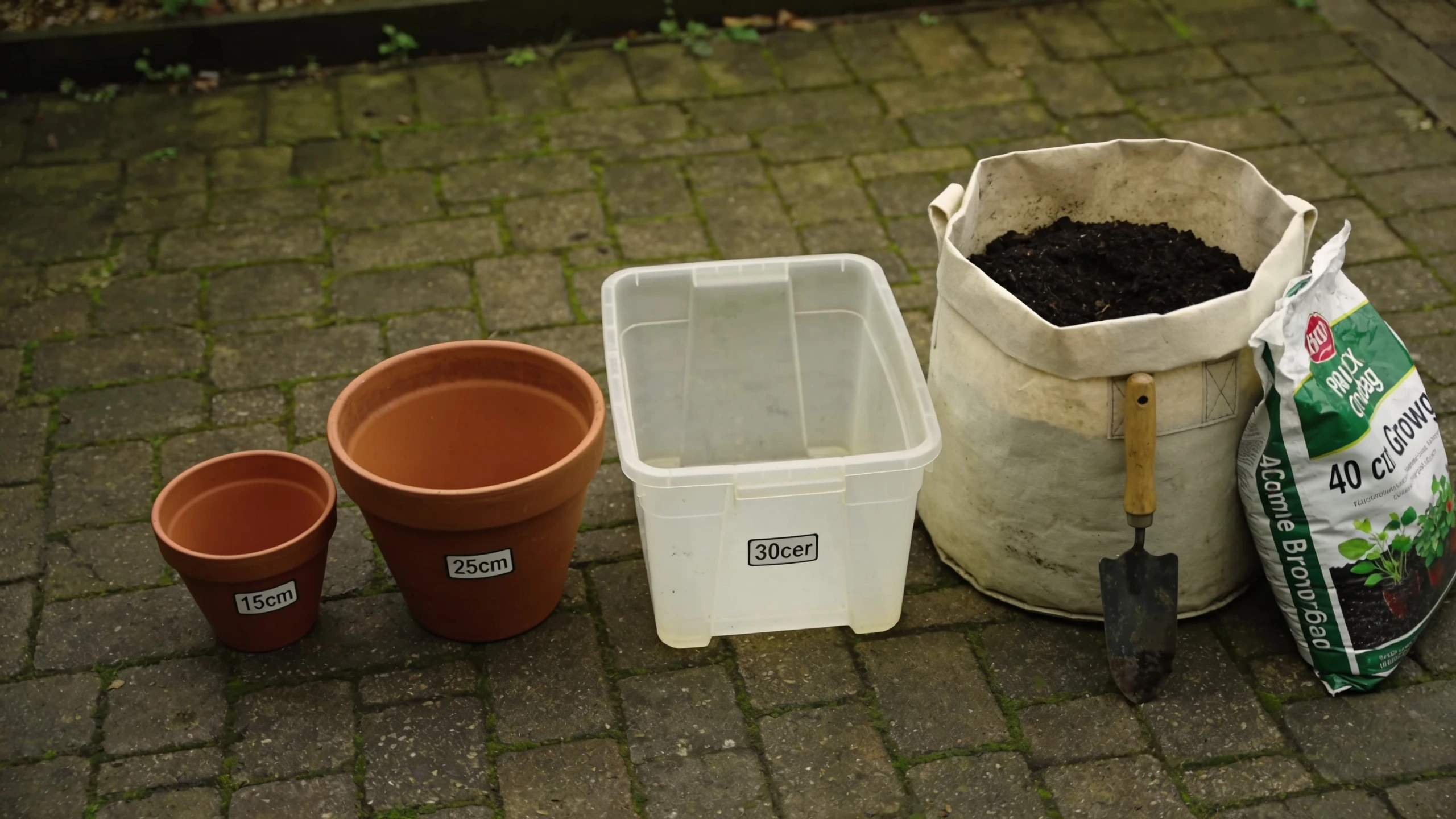 Container sizes for growing vegetables compared Four containers from a small terracotta pot to a 40 litre grow bag with compost